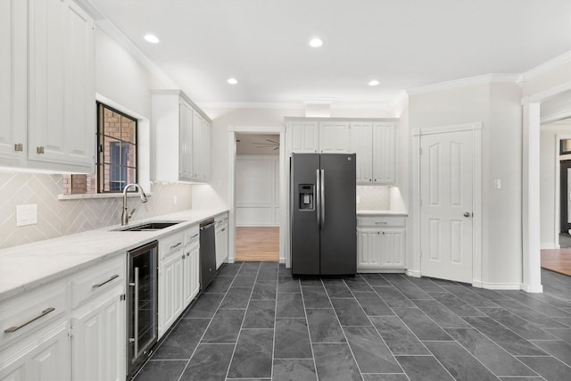 kitchen featuring wine cooler, dishwashing machine, a sink, stainless steel fridge, and white cabinetry