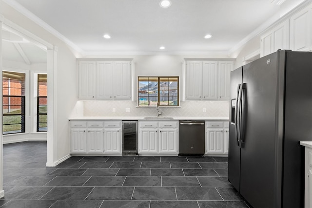 kitchen featuring sink, wine cooler, a wealth of natural light, white cabinetry, and stainless steel appliances