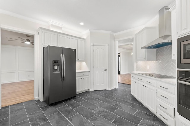 kitchen with ceiling fan, stainless steel appliances, wall chimney range hood, crown molding, and white cabinets