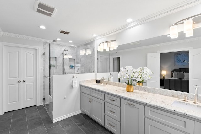 bathroom with visible vents, a sink, and crown molding