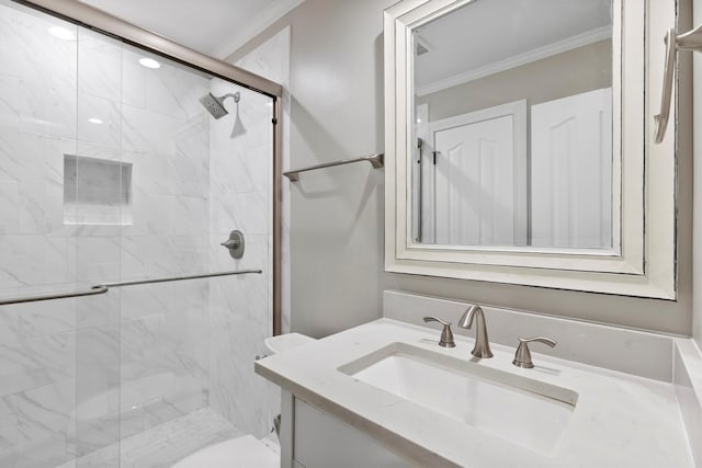 bathroom featuring ornamental molding, a stall shower, vanity, and toilet