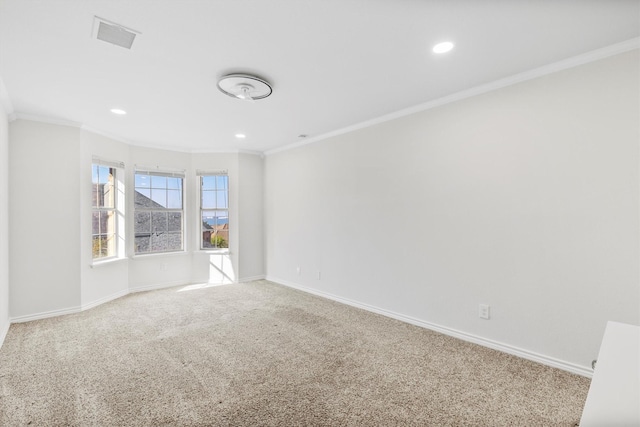 unfurnished room with crown molding and carpet floors