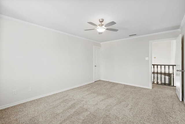 unfurnished room featuring carpet, ceiling fan, and ornamental molding