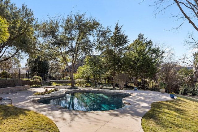 view of swimming pool with a lawn, fence, a fenced in pool, and a patio