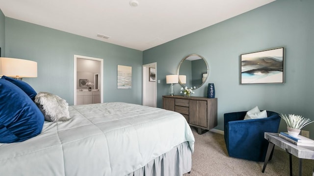 carpeted bedroom featuring ensuite bathroom