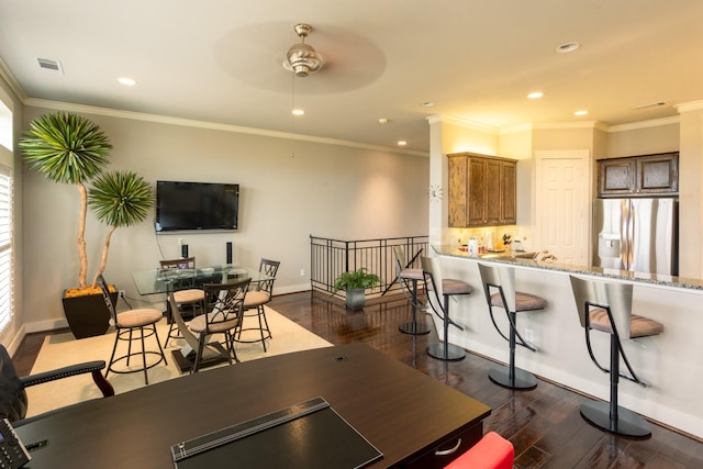 dining space featuring ceiling fan, crown molding, and dark wood-type flooring