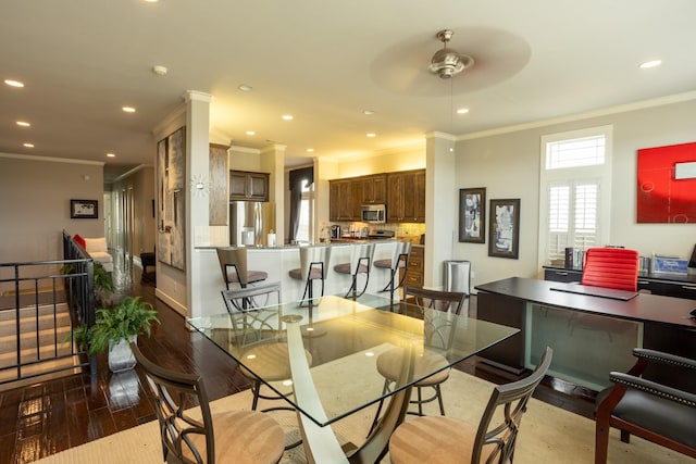 dining space with crown molding, ceiling fan, and wood-type flooring