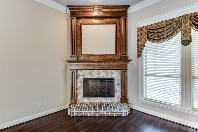 interior space with a tile fireplace, wood-type flooring, and ornamental molding