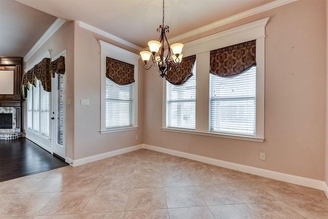 unfurnished dining area featuring a chandelier, crown molding, a wealth of natural light, and light hardwood / wood-style flooring