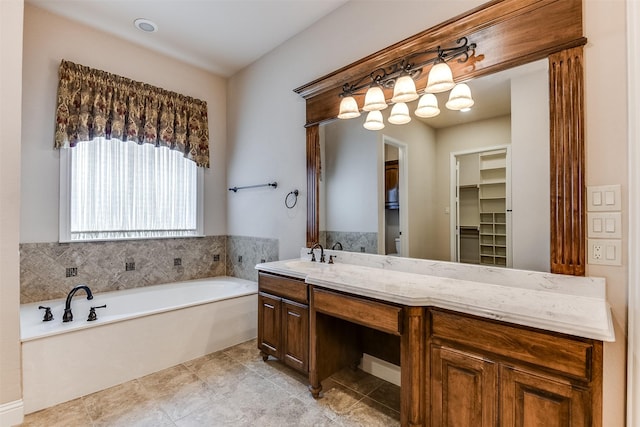 bathroom featuring vanity, tile patterned floors, and a tub