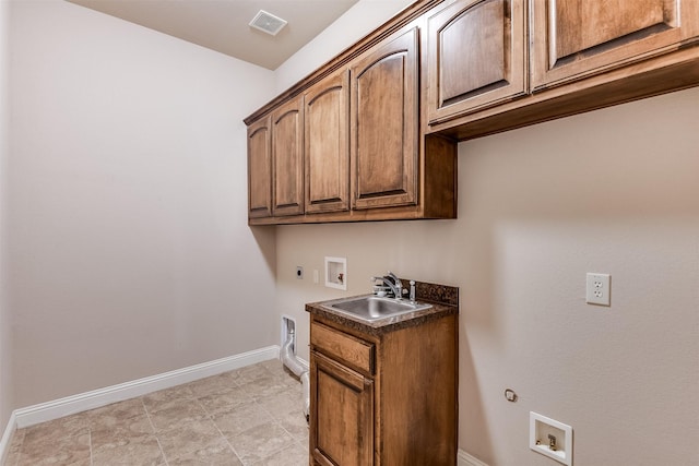 clothes washing area featuring cabinets, gas dryer hookup, sink, hookup for a washing machine, and hookup for an electric dryer