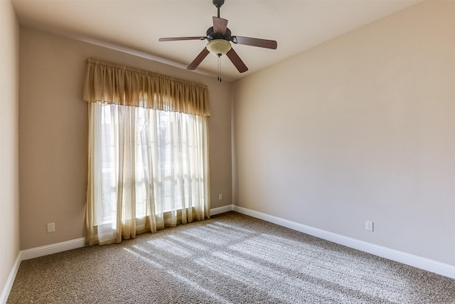 carpeted empty room featuring ceiling fan