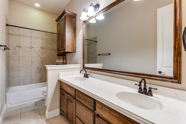 full bathroom featuring toilet, vanity, tile patterned floors, and tiled shower / bath