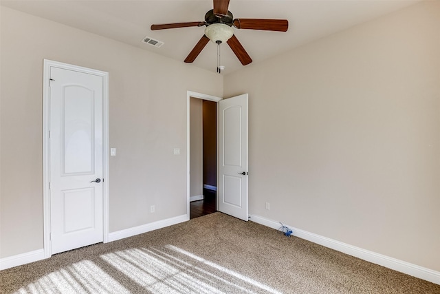 empty room featuring ceiling fan and carpet floors