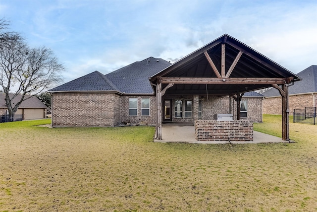 back of property with a patio and a yard