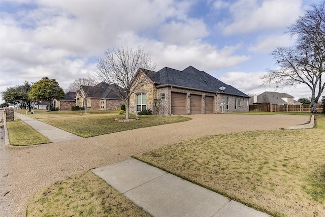 view of front of home with a front yard and a garage