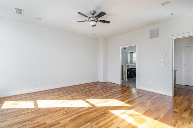 spare room featuring wood-type flooring and ceiling fan