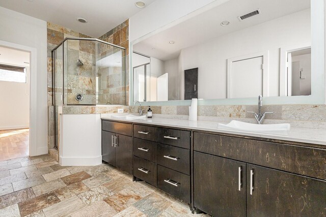 bathroom featuring vanity and an enclosed shower