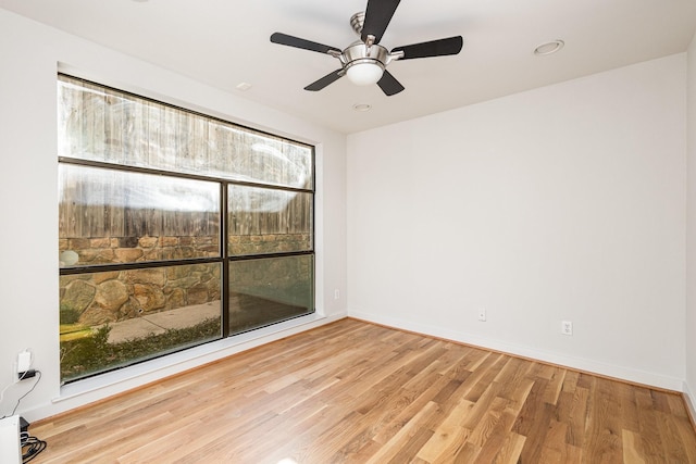 unfurnished room with ceiling fan and light hardwood / wood-style floors