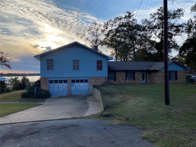 split level home with a garage and a lawn