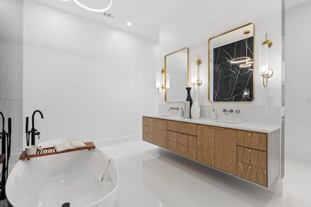 bathroom featuring a bathing tub, tile patterned flooring, and vanity