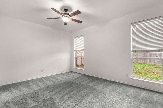 carpeted empty room featuring ceiling fan