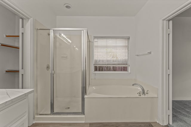 bathroom featuring vanity and shower with separate bathtub