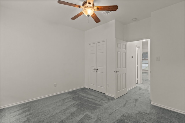 unfurnished bedroom with ceiling fan, a closet, and carpet