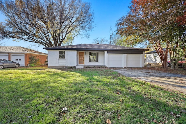 ranch-style house featuring a garage and a front lawn