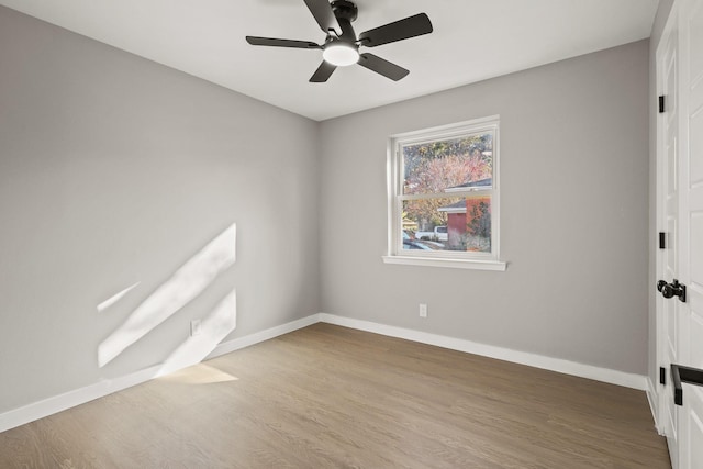 unfurnished room featuring hardwood / wood-style floors and ceiling fan