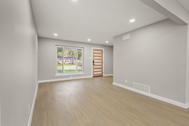 spare room featuring light hardwood / wood-style flooring