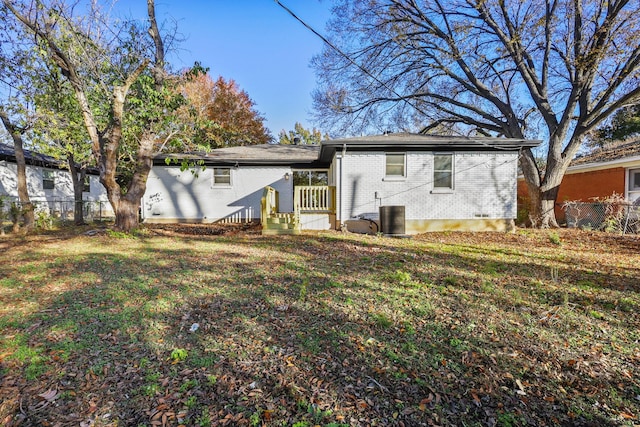 rear view of property featuring a lawn