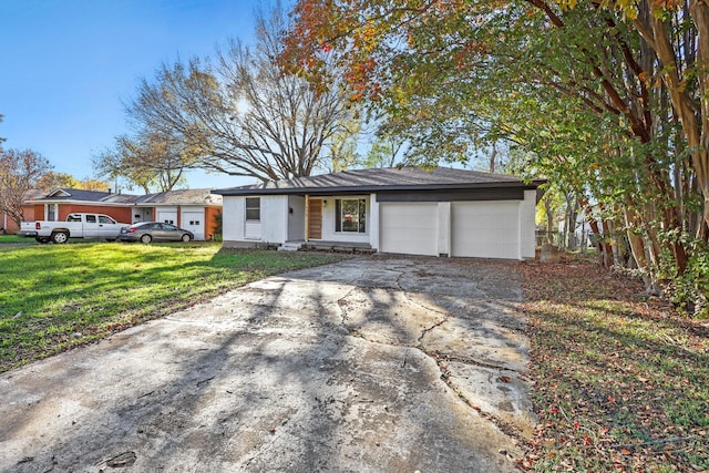 ranch-style home with a garage and a front lawn