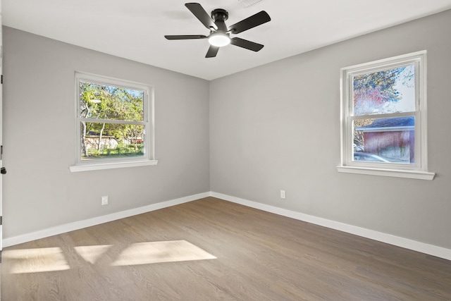 empty room with ceiling fan and wood-type flooring