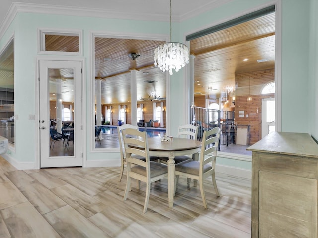 dining area featuring crown molding, wood ceiling, and an inviting chandelier