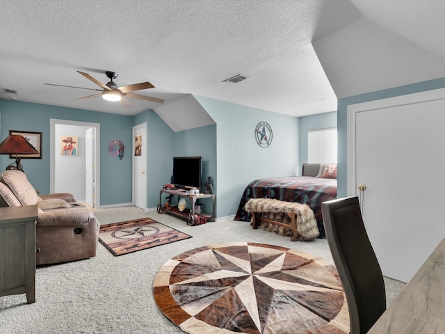 carpeted bedroom with ceiling fan and a textured ceiling