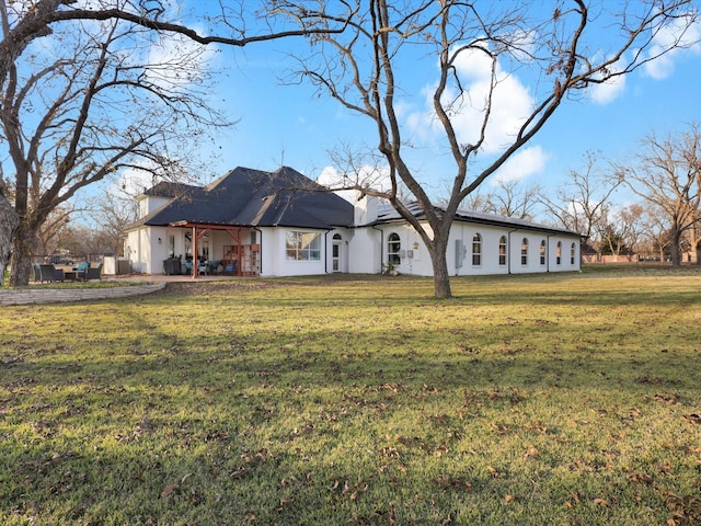 rear view of house with a lawn