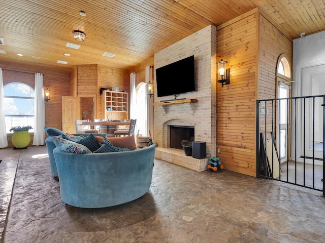 living room with wooden ceiling, a fireplace, and wooden walls