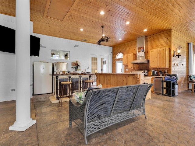 living room with a towering ceiling and wooden ceiling