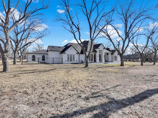 back of house featuring a yard and french doors