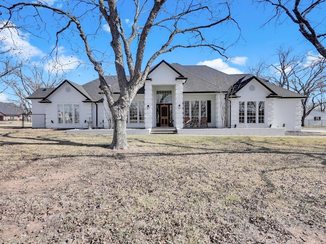 back of house with a lawn and french doors