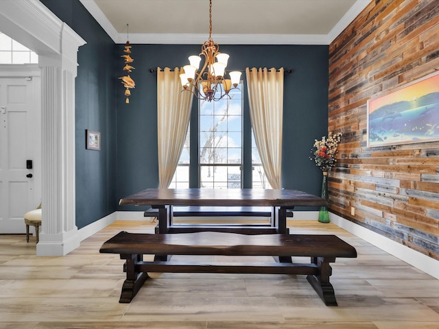 dining space featuring an inviting chandelier, a healthy amount of sunlight, and crown molding