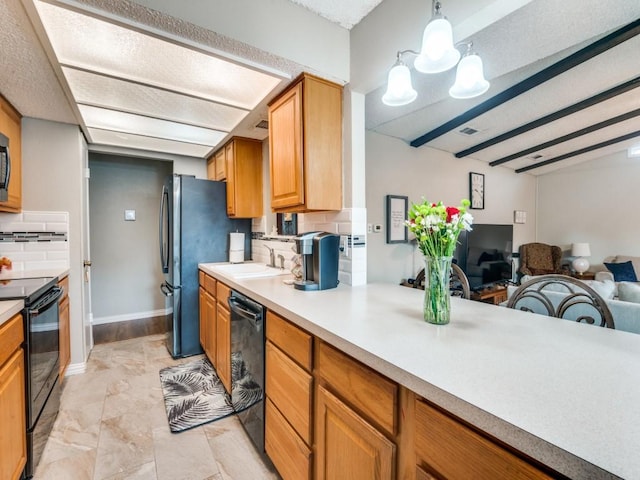 kitchen with sink, decorative light fixtures, black appliances, beamed ceiling, and backsplash