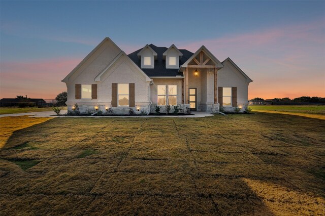 view of front of house with a yard