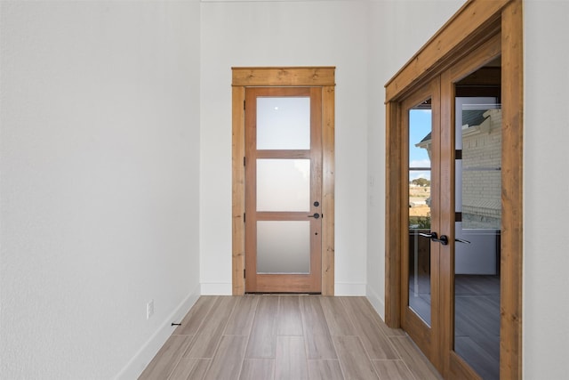 doorway featuring french doors and light hardwood / wood-style floors