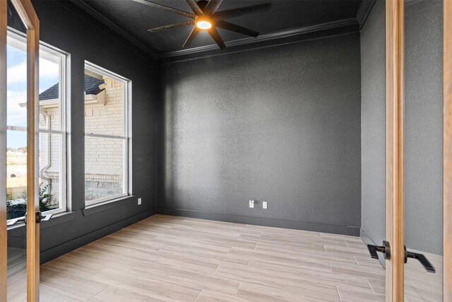 spare room with plenty of natural light, light hardwood / wood-style floors, and ornamental molding