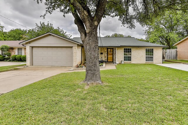 ranch-style house featuring a front lawn and a garage