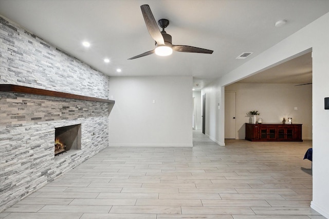 living room with ceiling fan and a fireplace