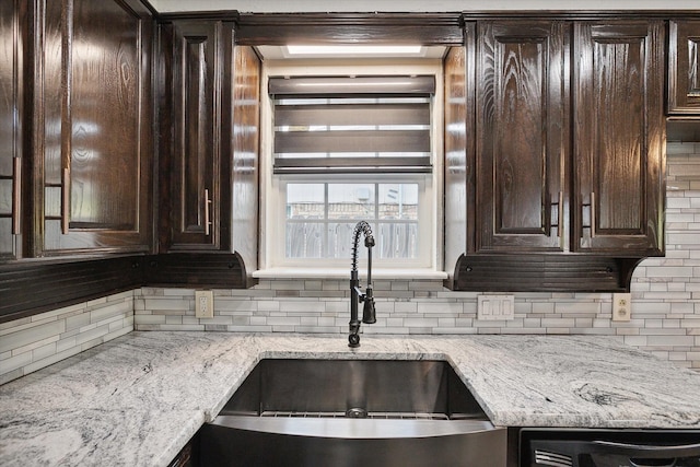 2100 Rockmoor Dr, Edgecliff Village, TX 76134 - kitchen featuring backsplash, dark brown cabinetry, and light stone counters