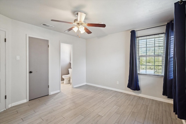 unfurnished bedroom featuring ceiling fan, light hardwood / wood-style floors, and ensuite bath